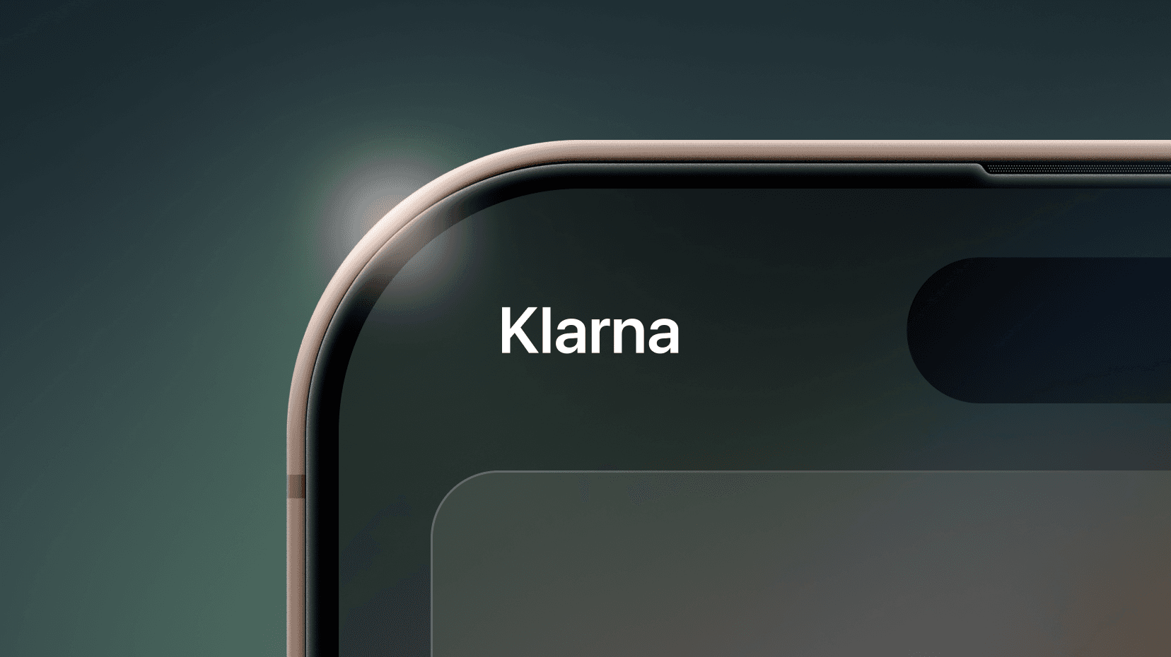 Close-up of a smartphone corner showing the word "Klarna" on the screen, with a sleek metallic edge and a dark background.